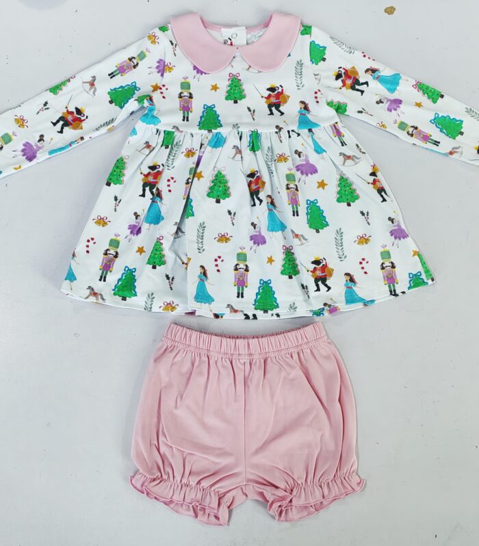 The infant and toddler set includes a "Nutcracker" themed dress and pink knickers