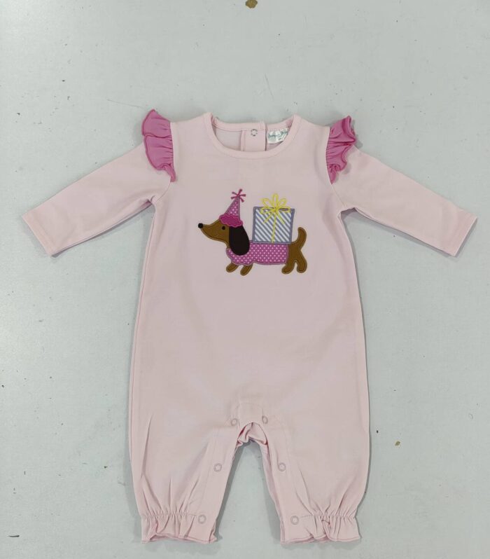 The baby onesie features a cute theme of a party dog